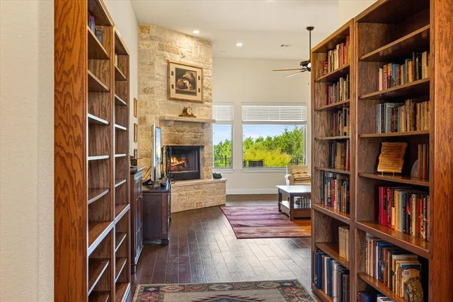 a living room with fireplace furniture and a book shelf