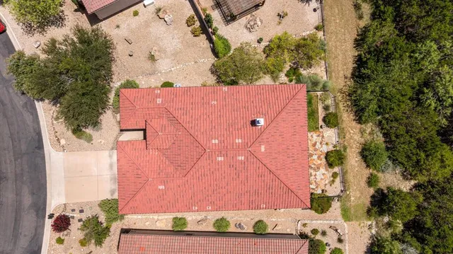 an aerial view of a house with a yard