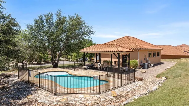 a front view of a house with garden and sitting area