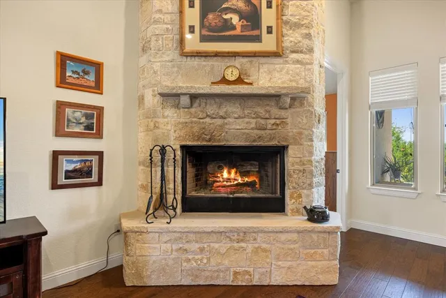 a living room with a fireplace with wooden floor