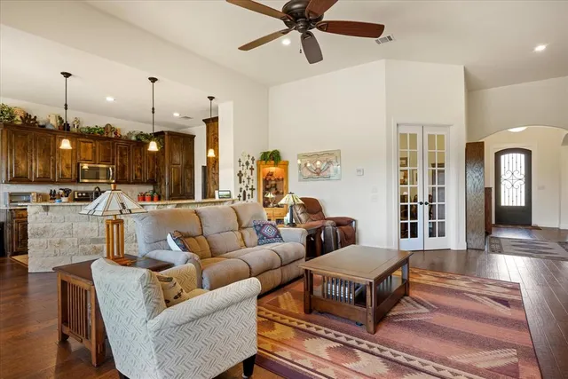 a living room with furniture and kitchen view