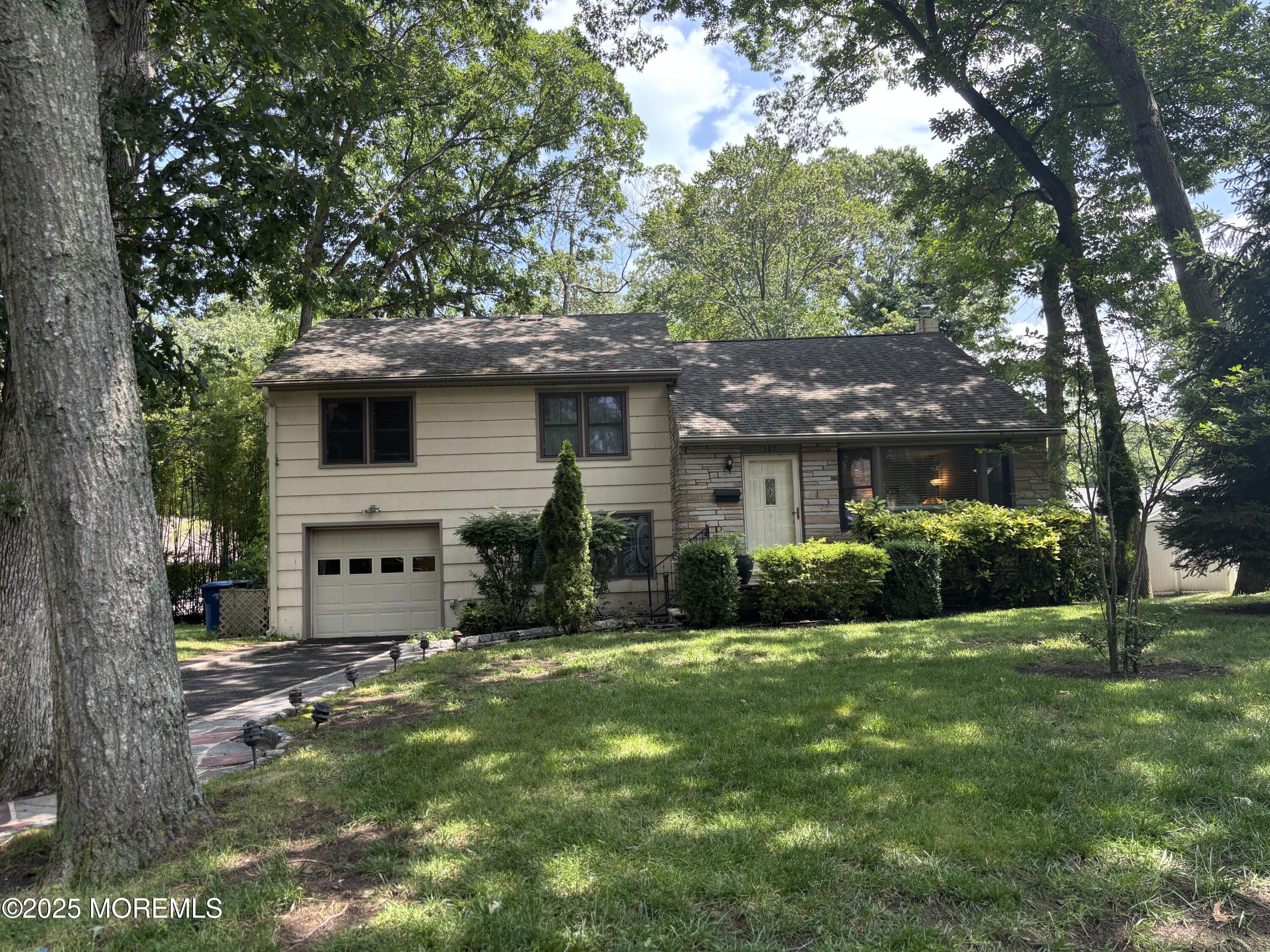 a front view of house with yard and green space