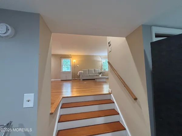a view of entryway and hall with wooden floor