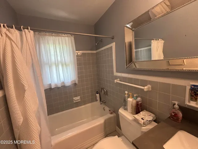 a bathroom with a sink and bathtub with shower