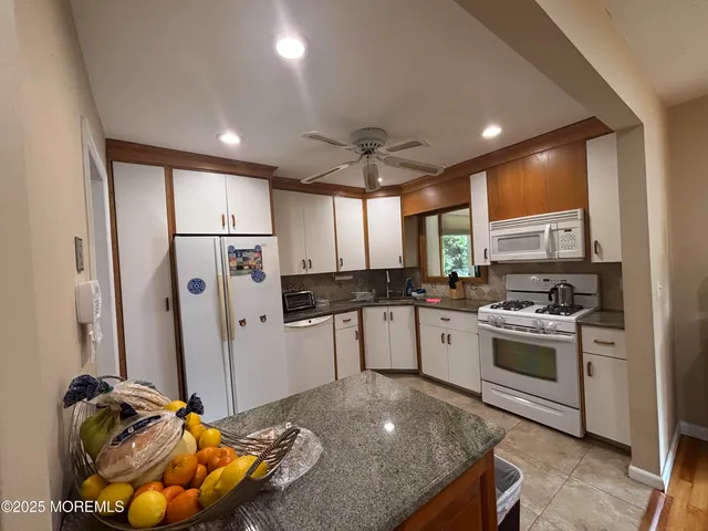 a kitchen with a sink appliances and cabinets