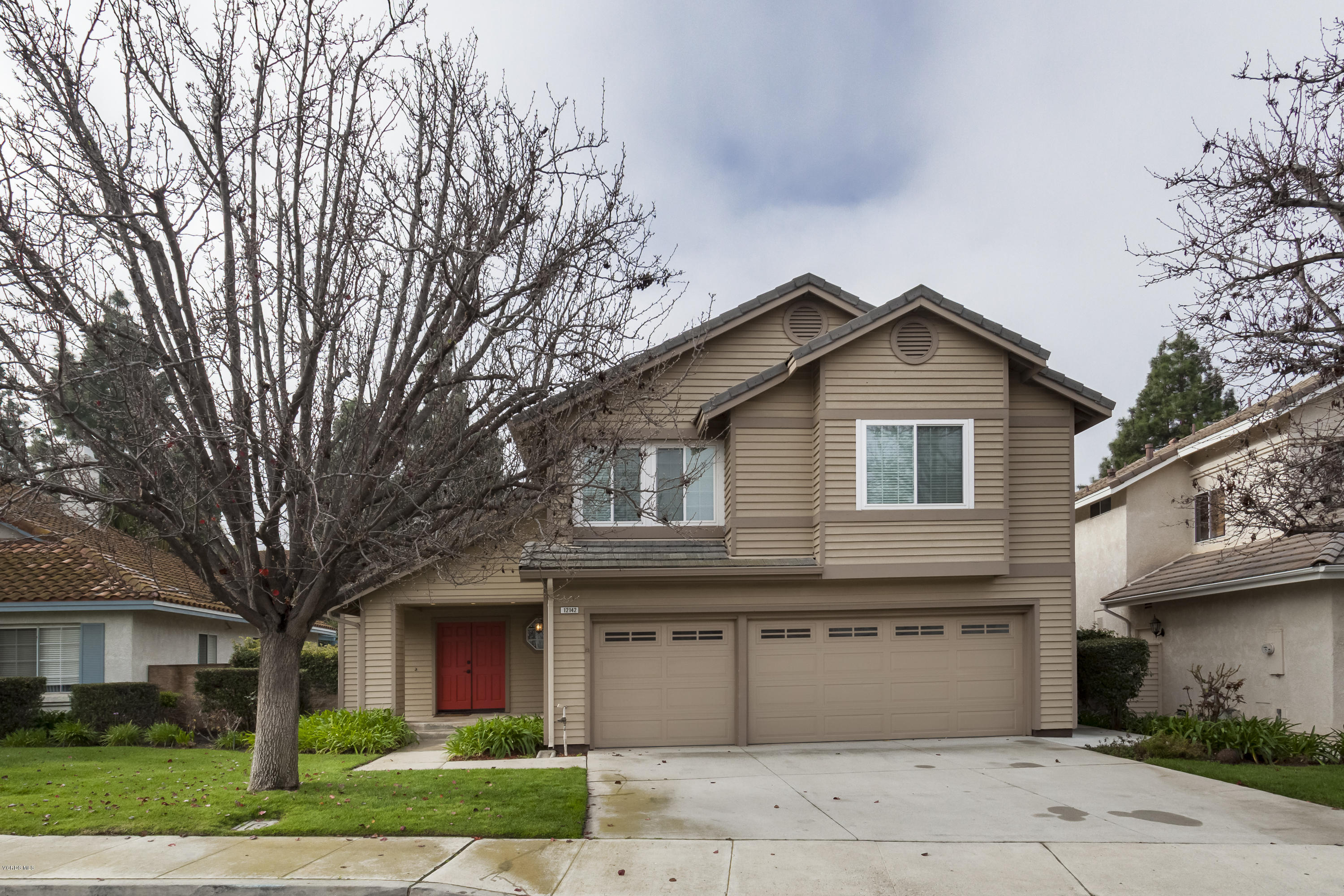 12142 Cherry Grove Street Moorpark, CA 93021 - Photo 1 of 36 a front view of a house with a yard and garage