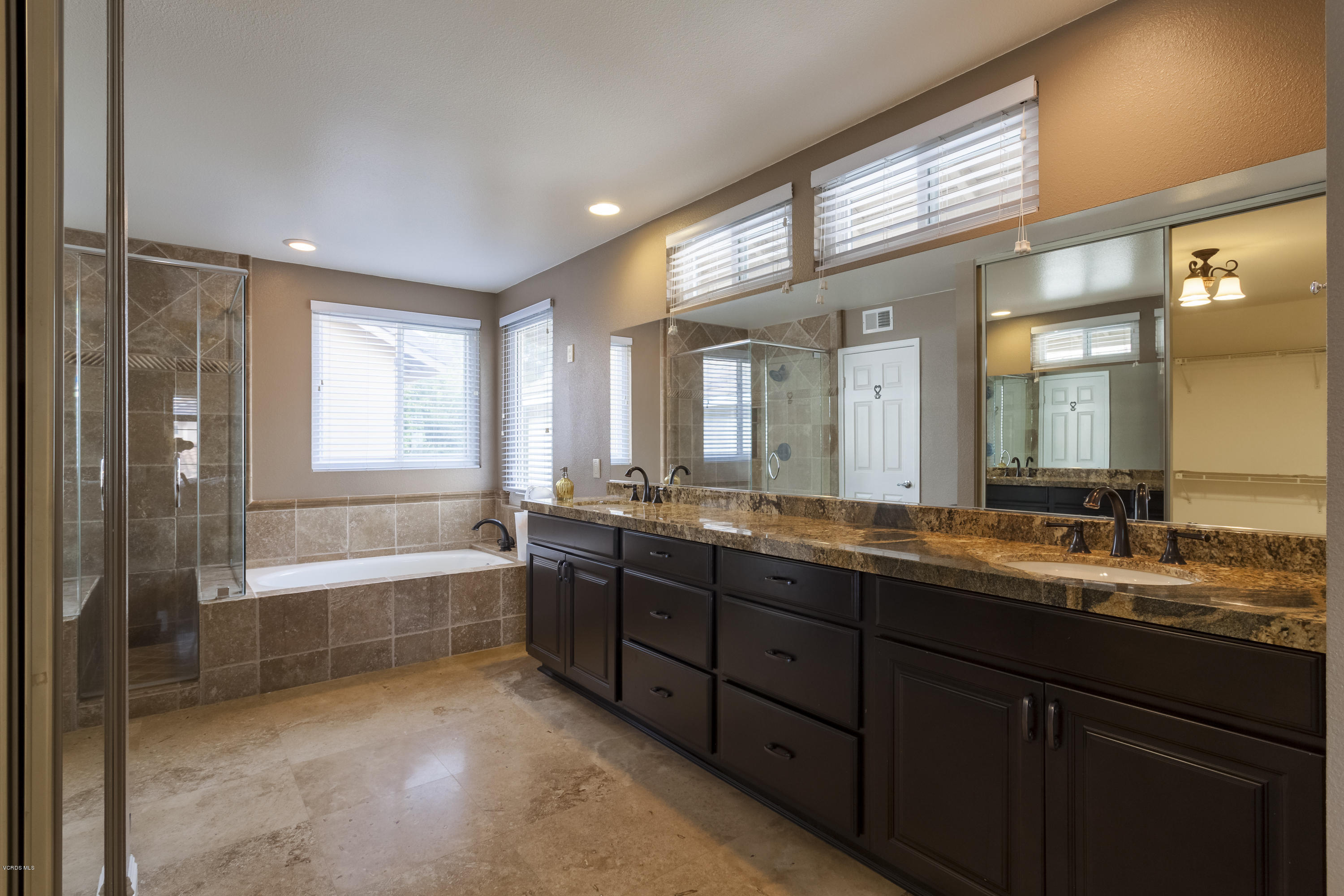 12142 Cherry Grove Street Moorpark, CA 93021 - Photo 14 of 36 a bathroom with a tub sink and mirror