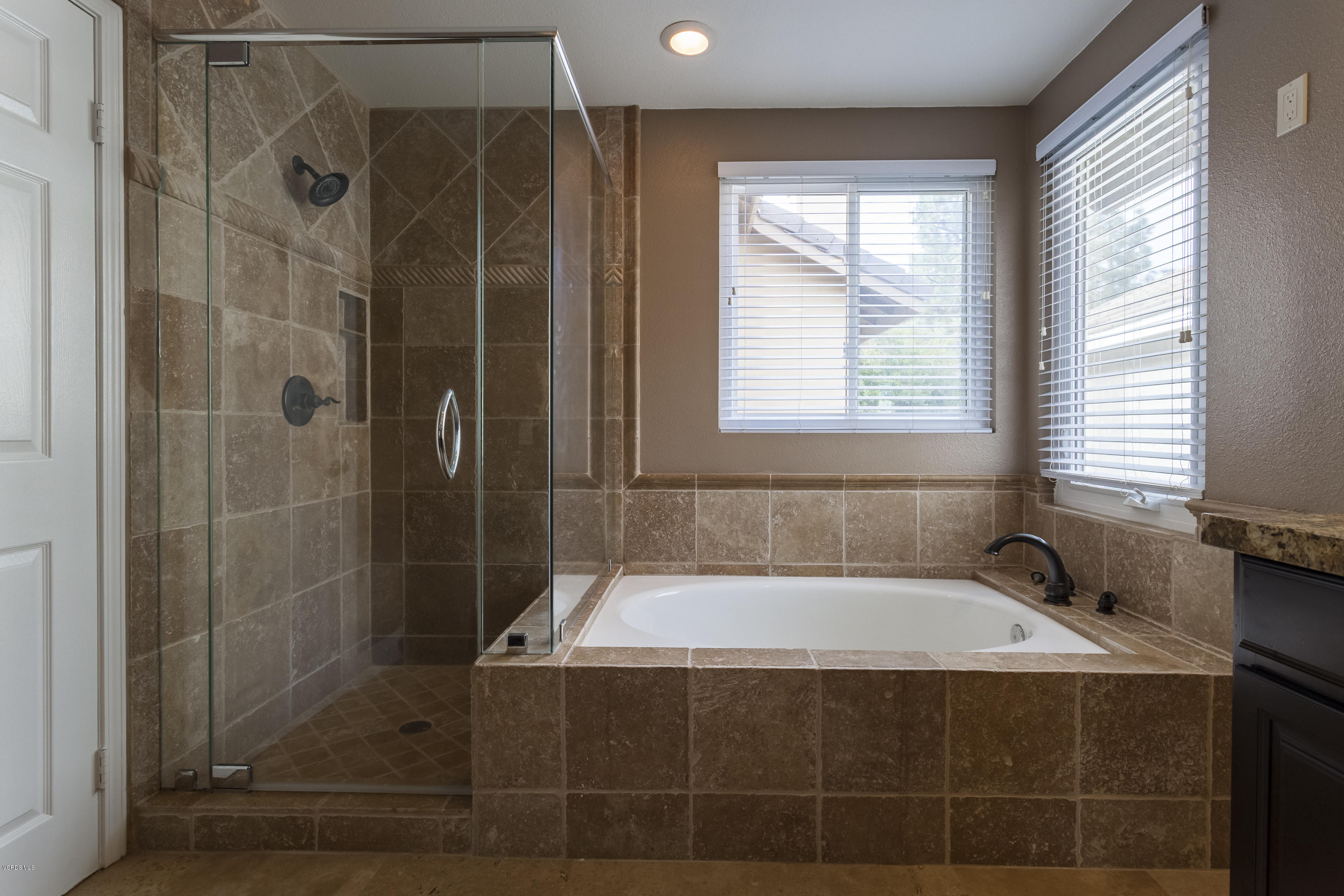 12142 Cherry Grove Street Moorpark, CA 93021 - Photo 15 of 36 a bathroom with a bathtub and window