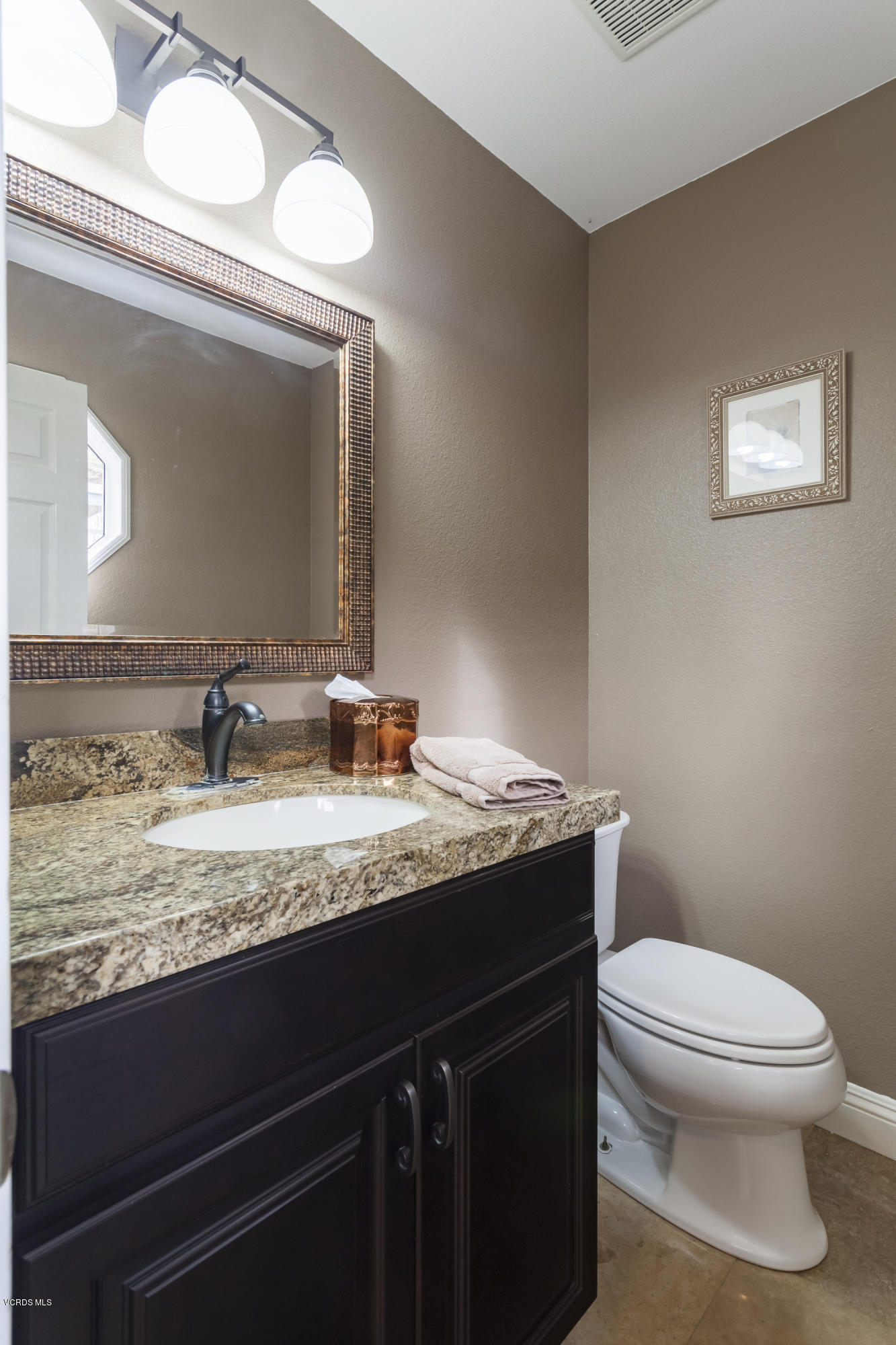 12142 Cherry Grove Street Moorpark, CA 93021 - Photo 17 of 36 a bathroom with a granite countertop toilet sink and mirror
