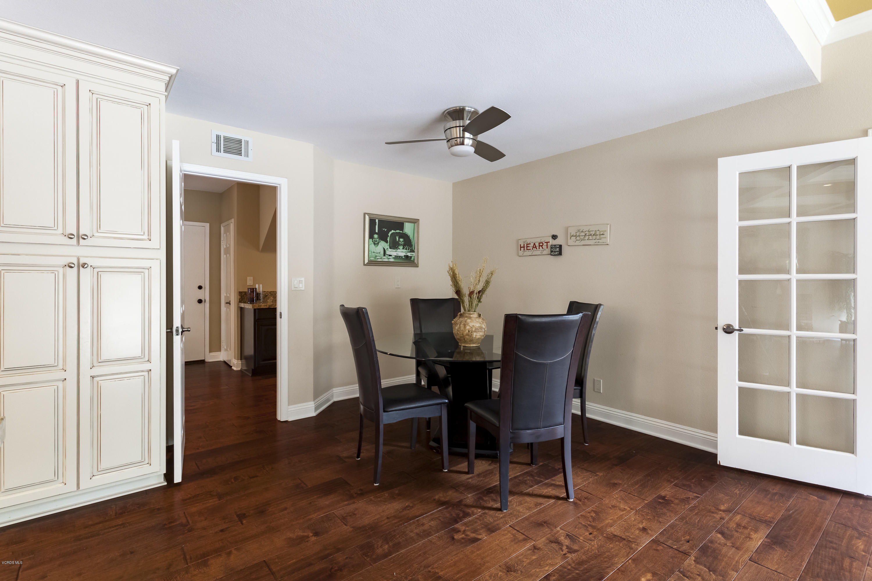 12142 Cherry Grove Street Moorpark, CA 93021 - Photo 20 of 36 a view of a dining room with furniture and wooden floor