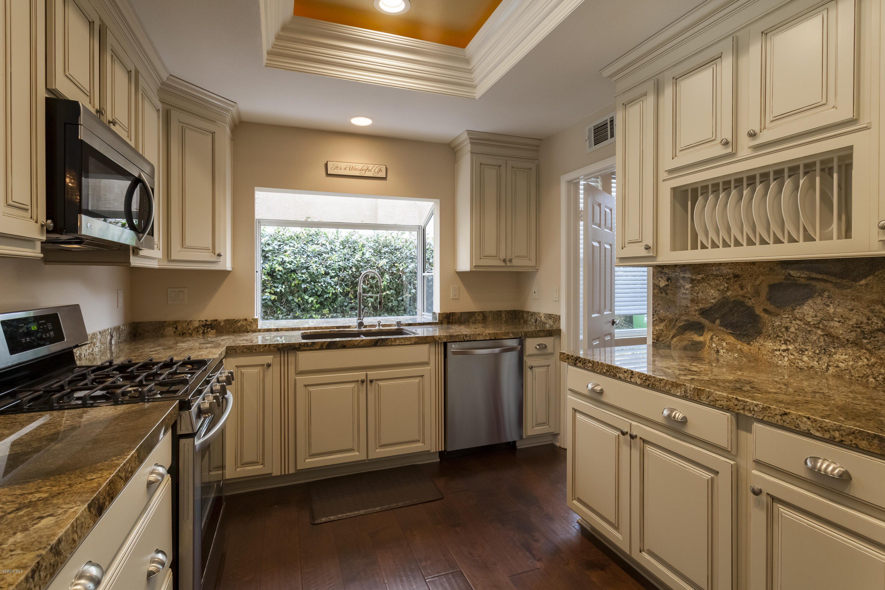 12142 Cherry Grove Street Moorpark, CA 93021 - Photo 3 of 36 a kitchen with stainless steel appliances granite countertop a stove a sink and a microwave
