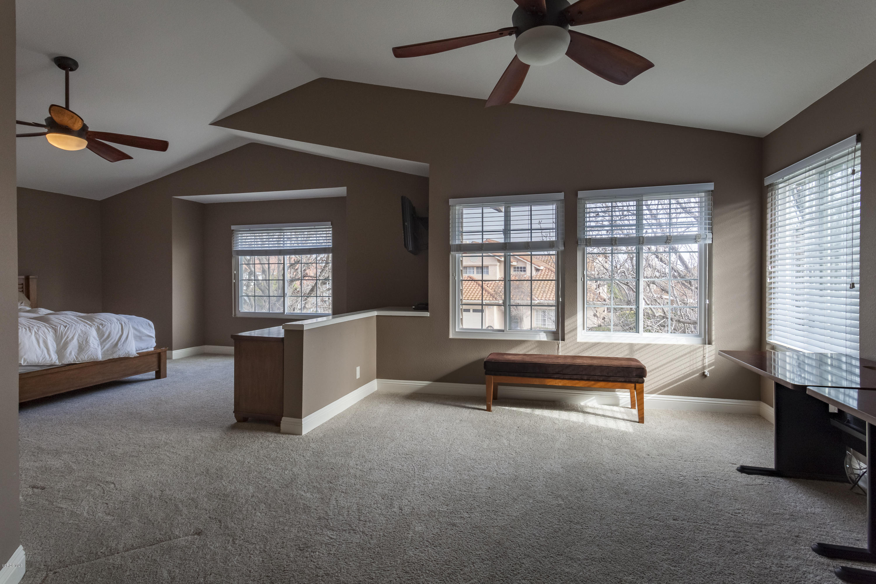 12142 Cherry Grove Street Moorpark, CA 93021 - Photo 23 of 36 a spacious bedroom with a bed and a chandelier