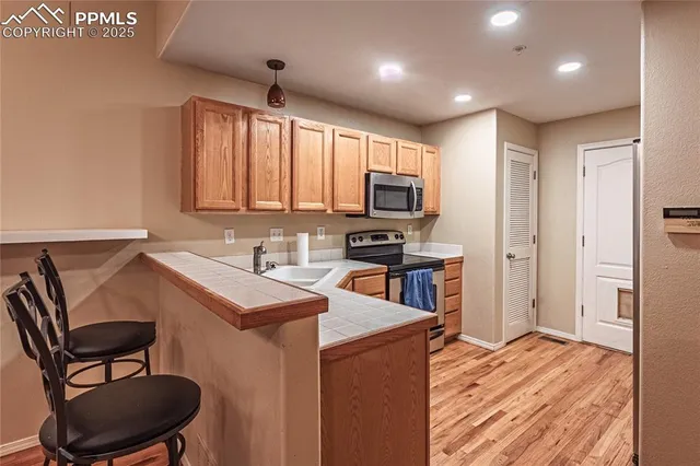 a kitchen that has a microwave a sink and a stove in it