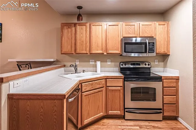 a kitchen with a sink stove and microwave