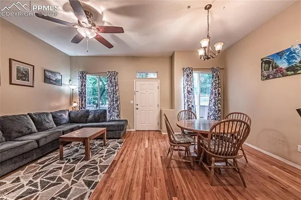 a living room with furniture and a chandelier