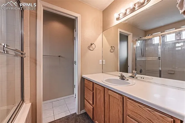 a bathroom with a double vanity sink and mirror