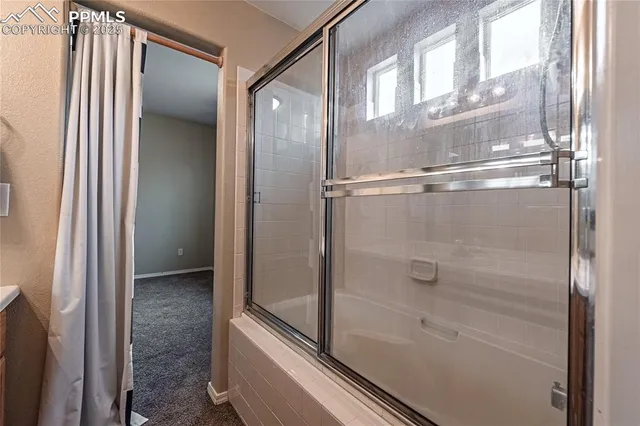 a bathroom with a glass shower door