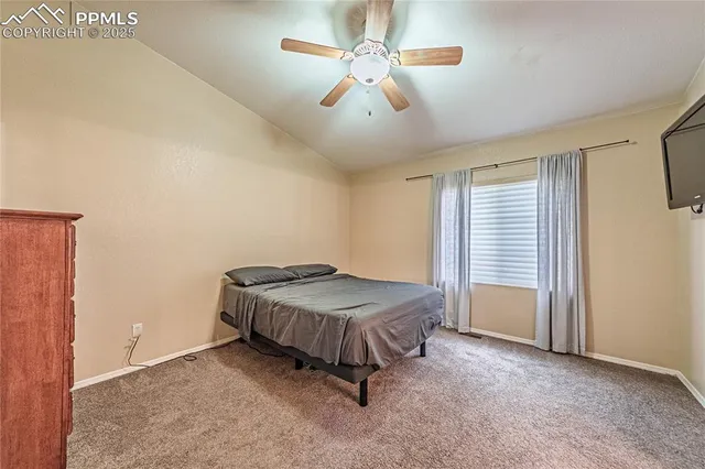 a spacious bedroom with a bed and a chandelier