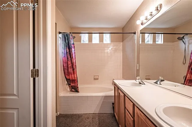 a bathroom with a tub sink and mirror