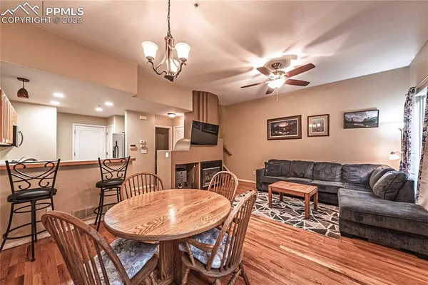 a living room with furniture a table and wooden floor
