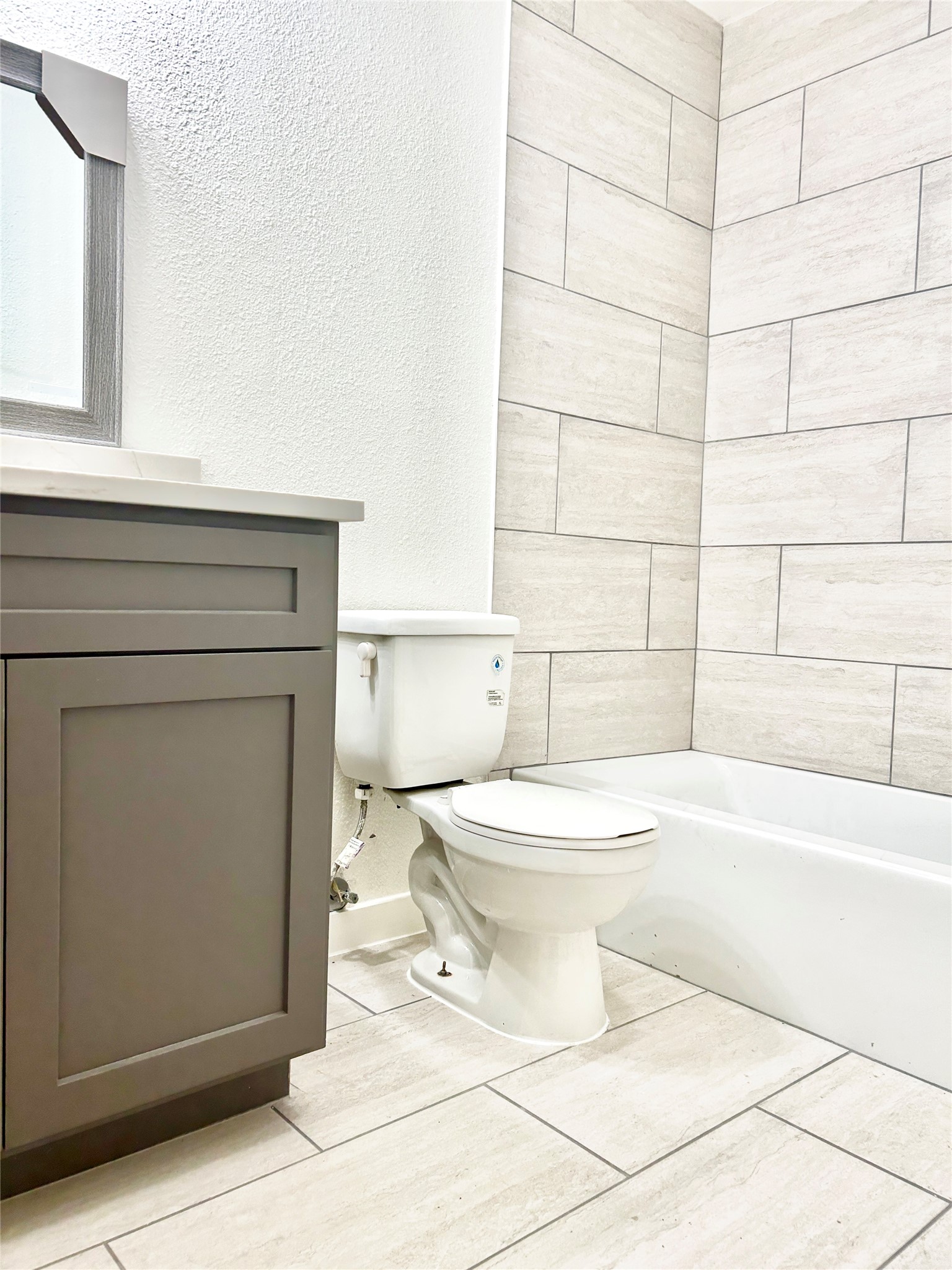 5903 Cougar Drive, Unit C Austin, TX 78745 - Photo 14 of 16 Bathroom with a bath, a textured wall, vanity, and tile patterned flooring