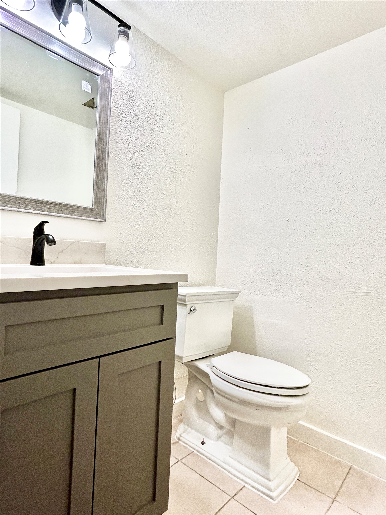 5903 Cougar Drive, Unit C Austin, TX 78745 - Photo 16 of 16 Bathroom featuring a textured wall, tile patterned floors, vanity, and a textured ceiling