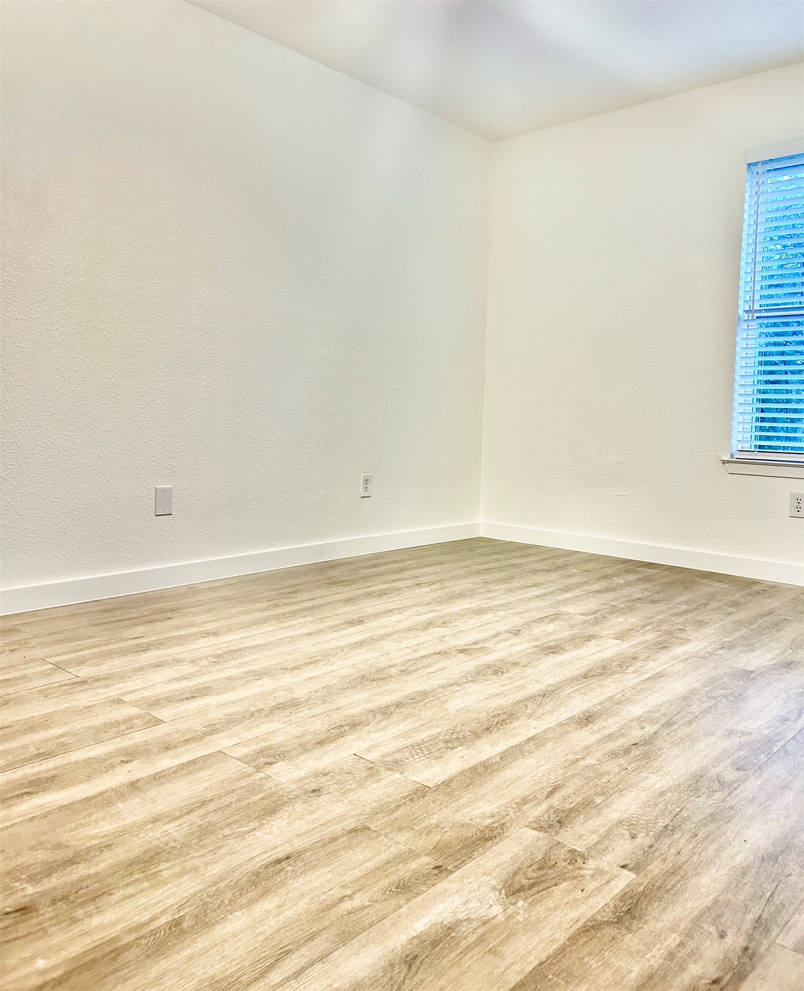 5903 Cougar Drive, Unit C Austin, TX 78745 - Photo 4 of 16 Empty room featuring wood finished floors and baseboards