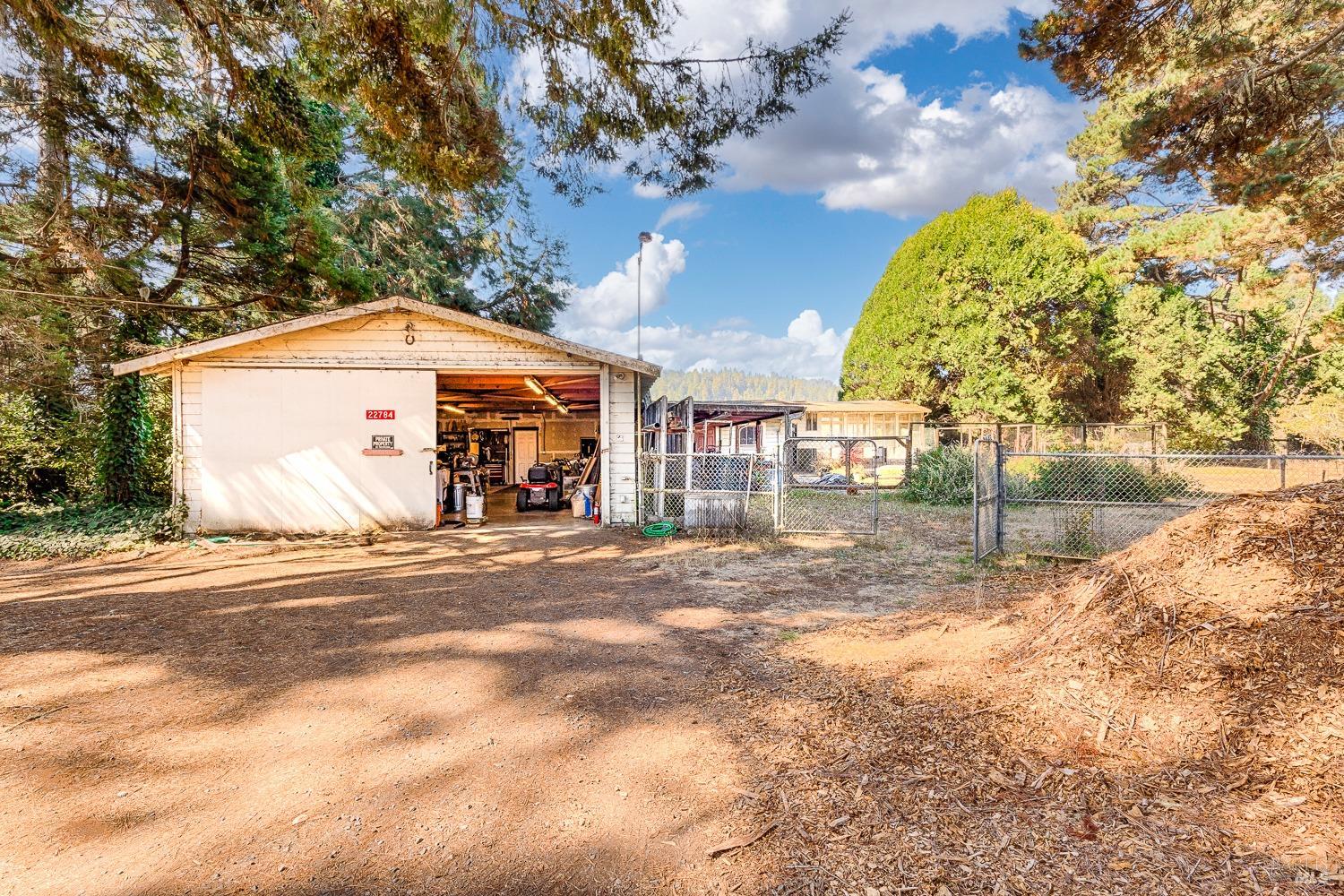 22776 Moscow Road Monte Rio, CA 95462 - Photo 14 of 20 a view of a house with a yard and large trees