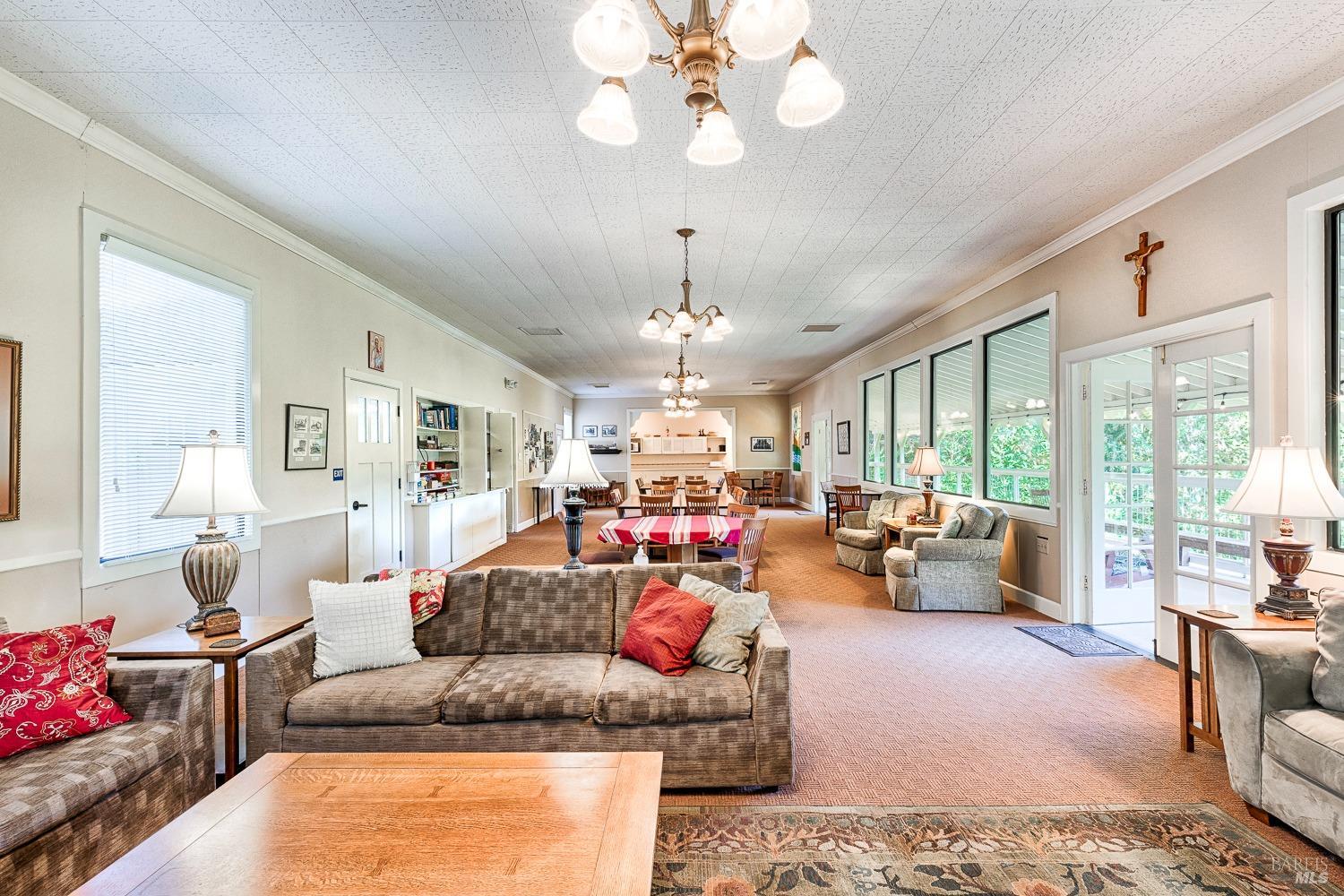 22776 Moscow Road Monte Rio, CA 95462 - Photo 7 of 20 a living room with fireplace furniture and a large window
