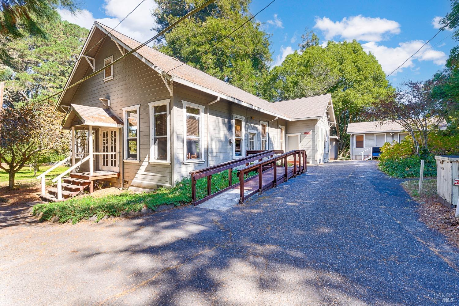 22776 Moscow Road Monte Rio, CA 95462 - Photo 9 of 20 a view of a white house with a large space and a road