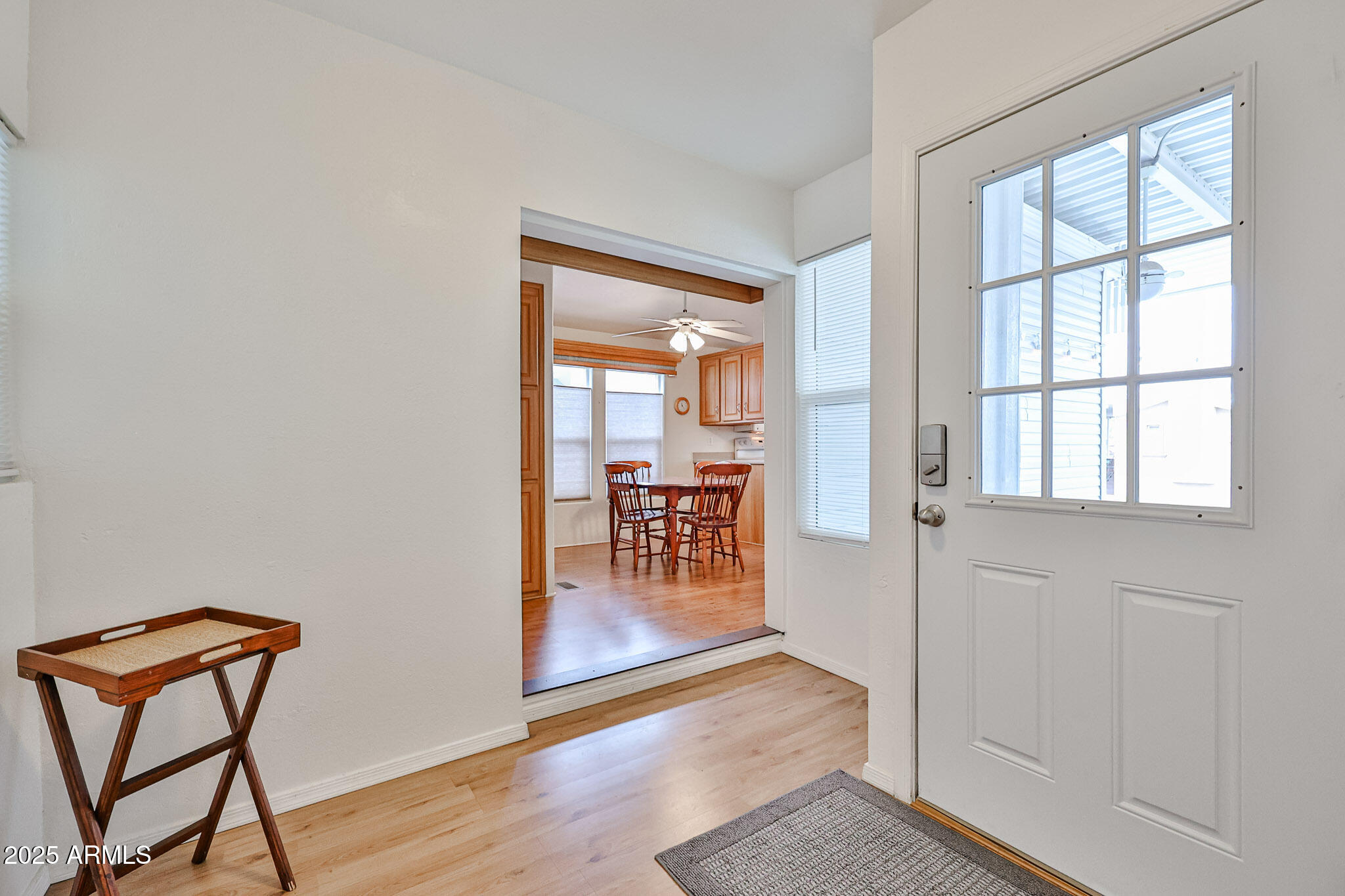 17200 West Bell Road, Unit 1185 Surprise, AZ 85374 - Photo 13 of 44 a view of a hallway with wooden floor and a dining room