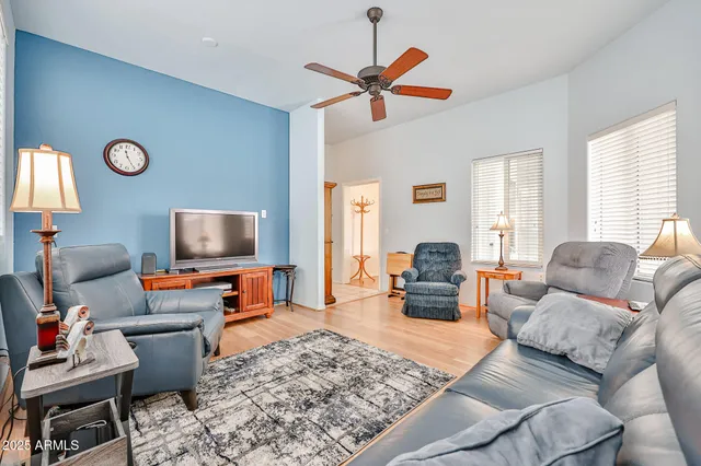 a living room with furniture kitchen view and a window