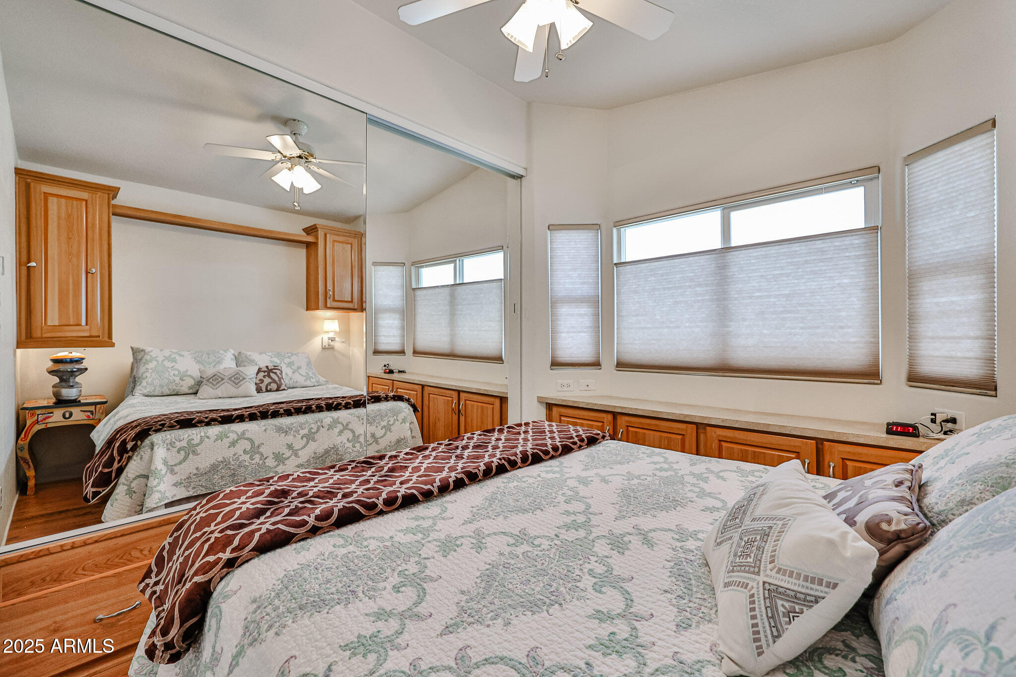 17200 West Bell Road, Unit 1185 Surprise, AZ 85374 - Photo 17 of 44 a bedroom with a large bed and a chandelier