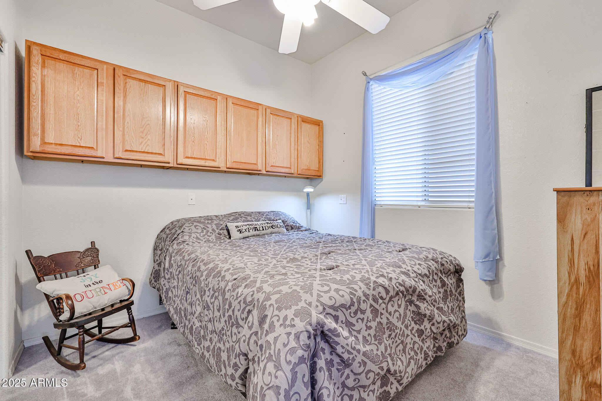 17200 West Bell Road, Unit 1185 Surprise, AZ 85374 - Photo 19 of 44 a bedroom with a bed and chair