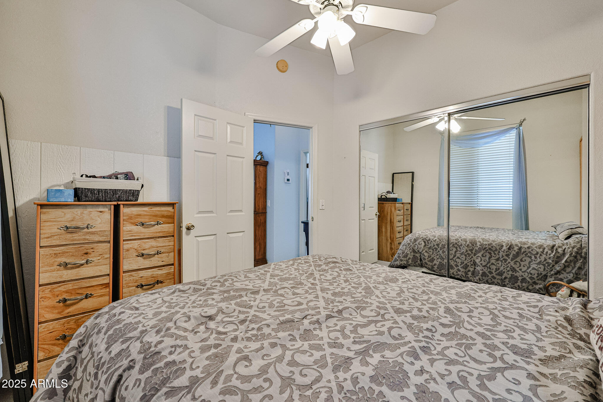 17200 West Bell Road, Unit 1185 Surprise, AZ 85374 - Photo 21 of 44 a bedroom with a bed and a chandelier