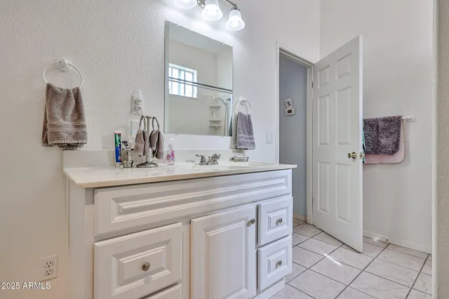 a bathroom with a sink vanity and mirror
