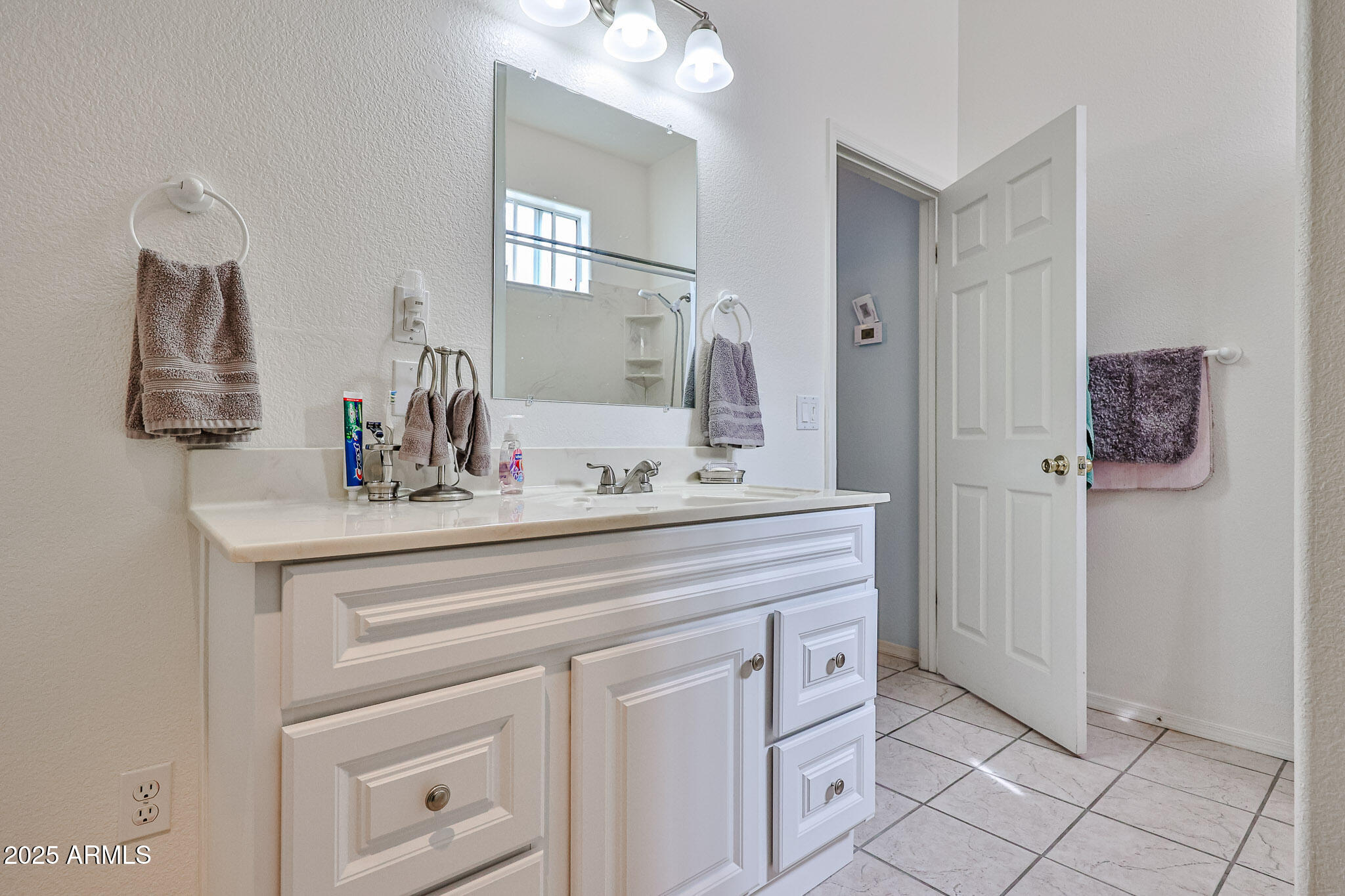 17200 West Bell Road, Unit 1185 Surprise, AZ 85374 - Photo 22 of 44 a bathroom with a sink vanity and mirror