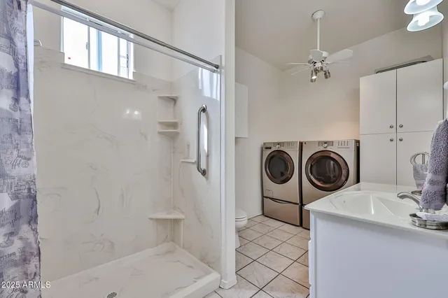 a bathroom with a sink a toilet and a shower