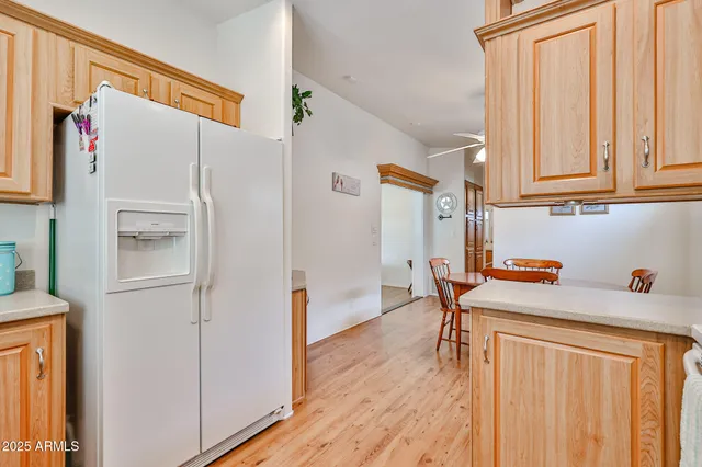 a kitchen with stainless steel appliances a refrigerator and a cabinets