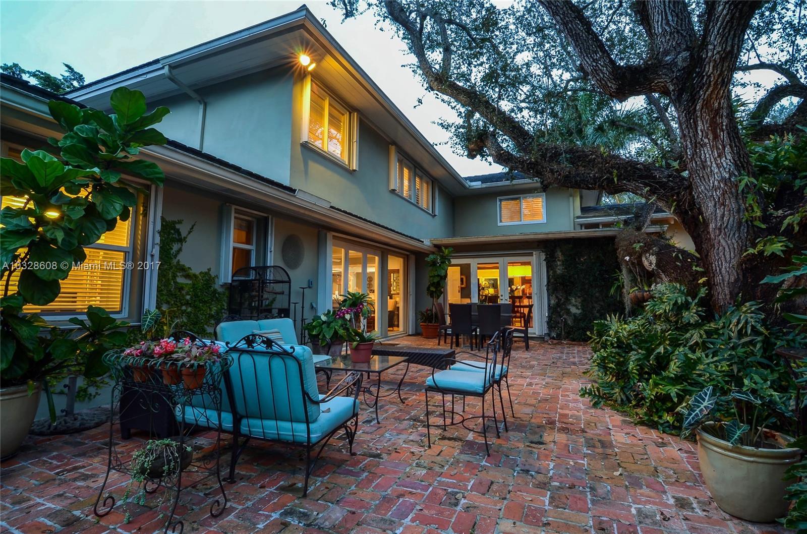 8150 Erwin Road Miami, FL 33143 - Photo 13 of 36 a view of a house with a chairs and table in a patio