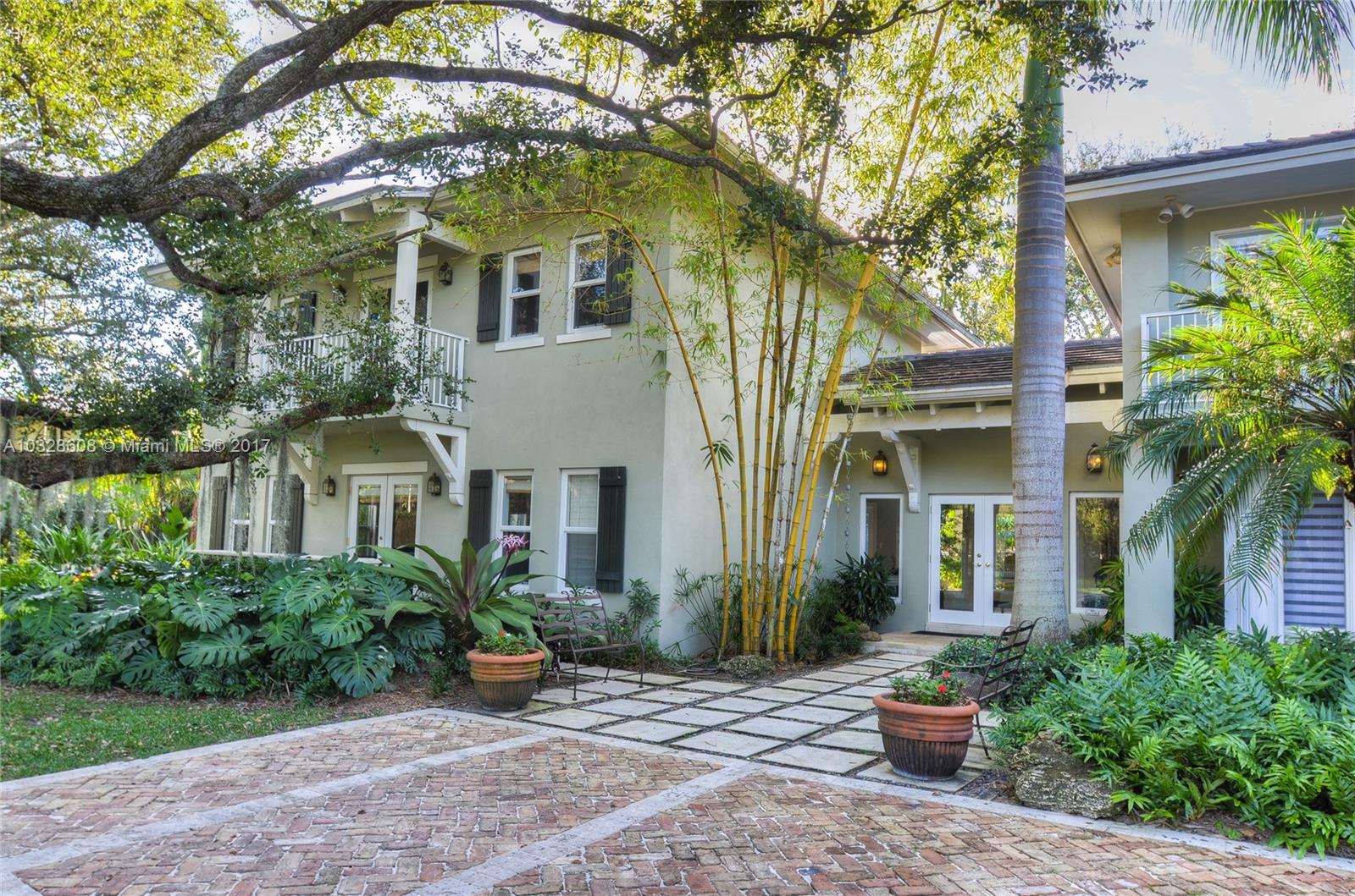 8150 Erwin Road Miami, FL 33143 - Photo 2 of 36 front view of a house with potted plants and a large tree