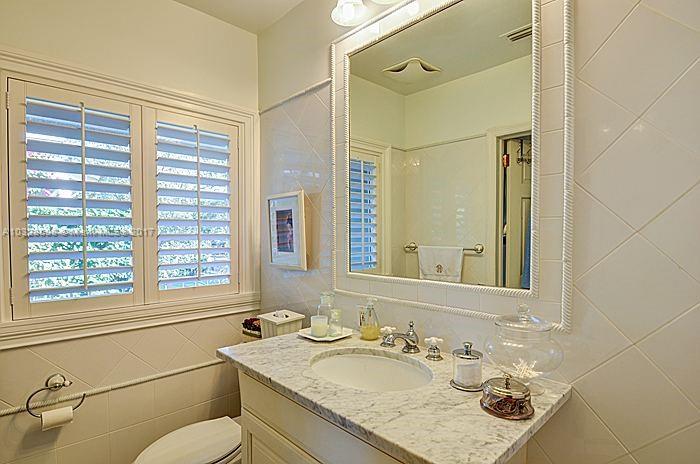 8150 Erwin Road Miami, FL 33143 - Photo 21 of 36 a bathroom with a granite countertop sink toilet and shower