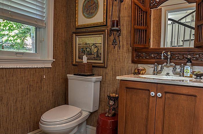 8150 Erwin Road Miami, FL 33143 - Photo 27 of 36 a bathroom with a toilet a sink and mirror