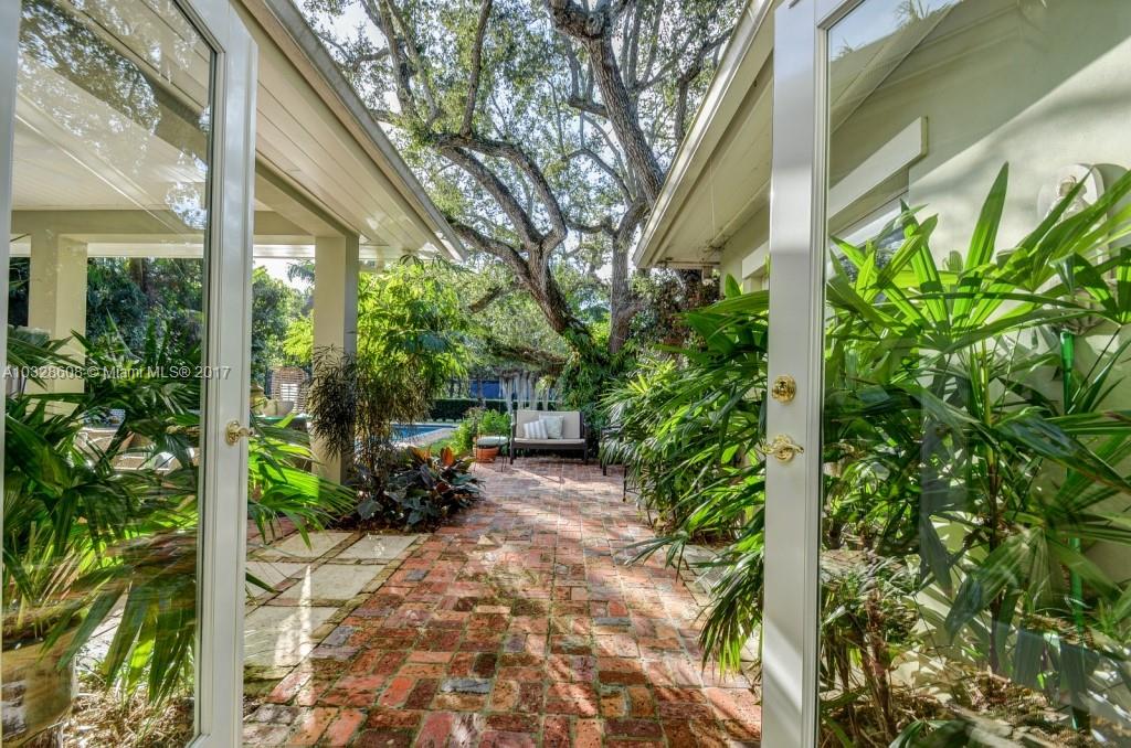 8150 Erwin Road Miami, FL 33143 - Photo 7 of 36 a backyard of a house with outdoor seating and green space