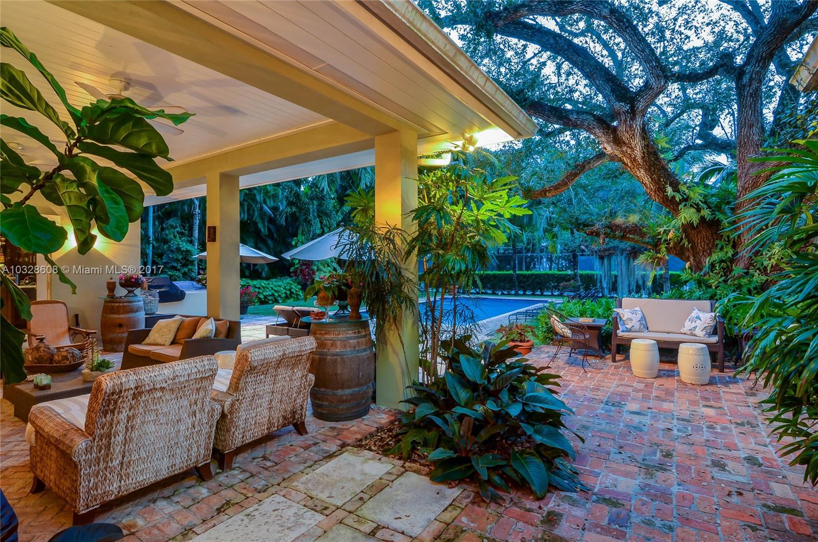 8150 Erwin Road Miami, FL 33143 - Photo 9 of 36 a backyard of a house with barbeque oven table and chairs