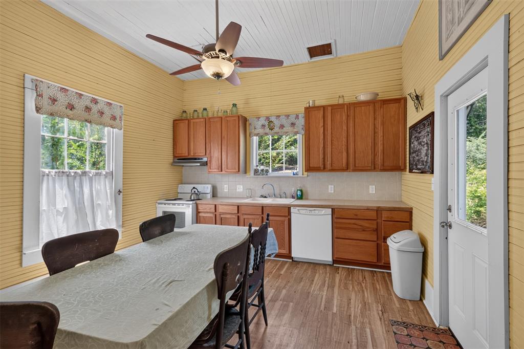 3470 State Rte 531 Dubberly, LA 71024 - Photo 19 of 34 Kitchen featuring wood-finish flooring, wood cabinetry, built-in dishwasher, and a ceiling fan