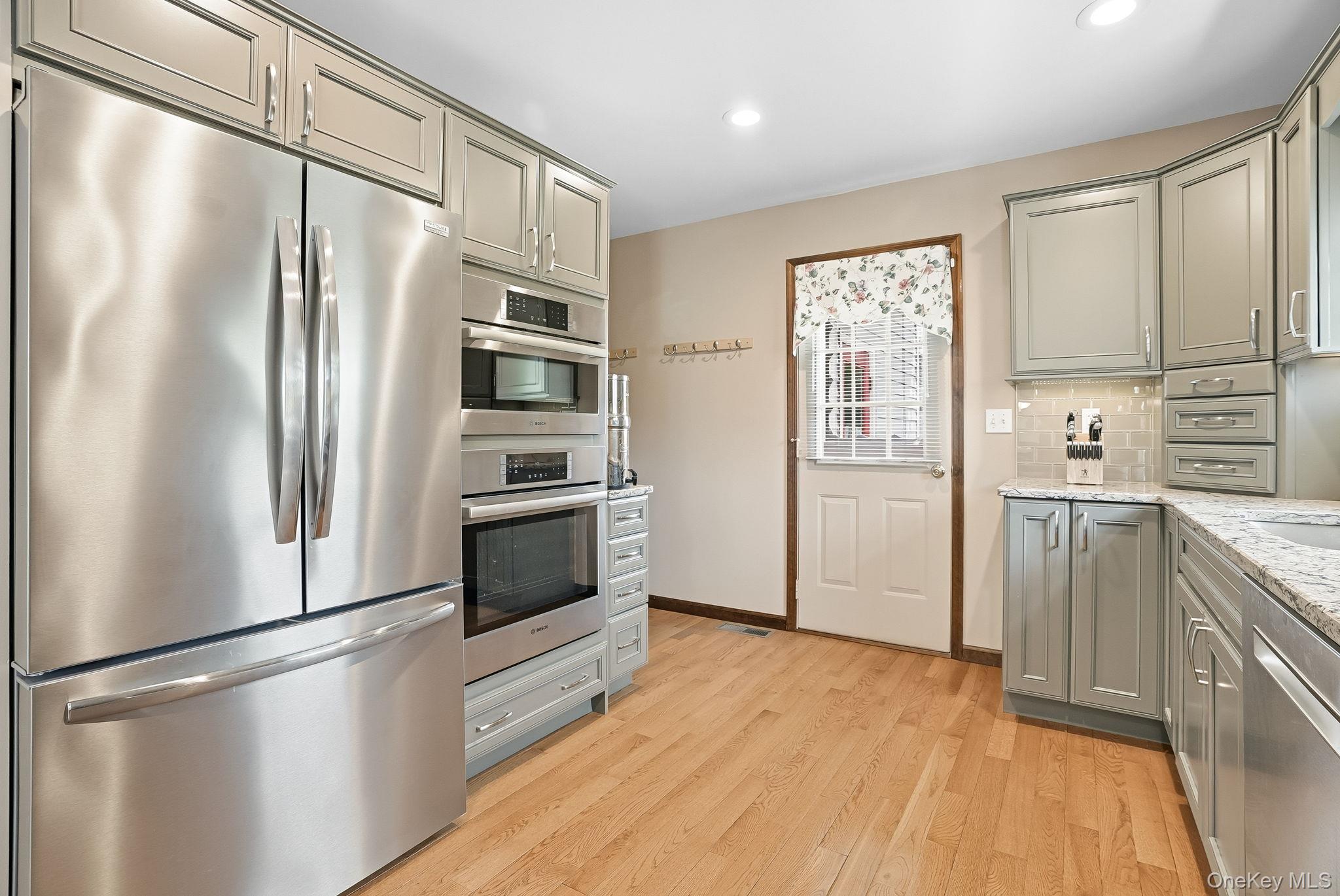 73 Sunset Road Montrose, NY 10548 - Photo 22 of 41 The cook will appreciate the Bosch induction cooktop, combo microwave, wall oven and dishwasher.