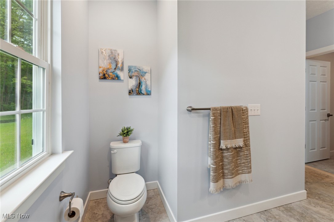 7605 Lake Road East Madison, OH 44057 - Photo 24 of 50 Bathroom with toilet and baseboards