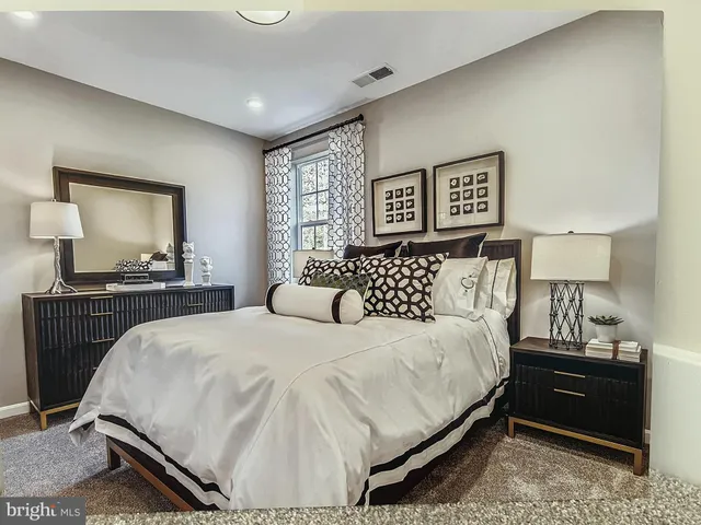 a bedroom with a bed and a night stand