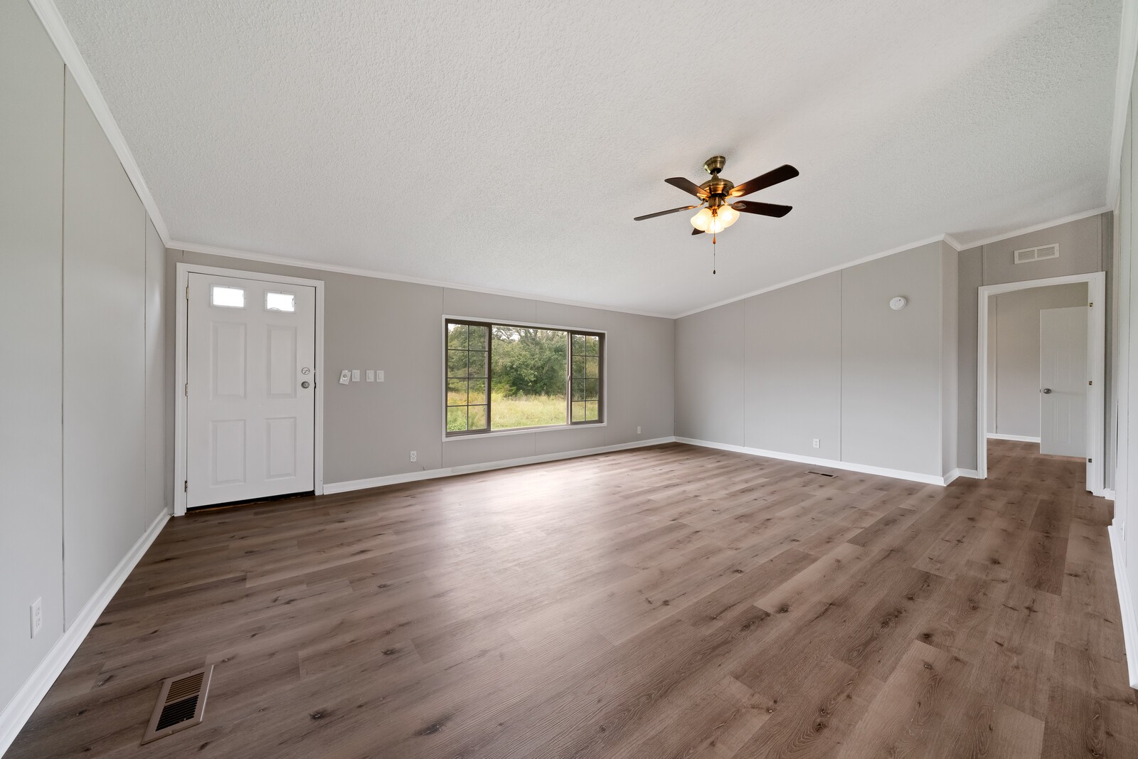 450 Obie Adcock Road Smithville, TN 37166 - Photo 2 of 30 an empty room with fan and windows